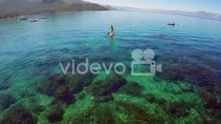 An aerial shot over a paddle boarder rowing on Lake Tahoe　石川崇弘