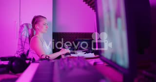 Woman Browsing Internet On Smartphone While Working On Computer At Home Office　江渡賢慈