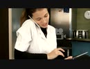 Smiling spa manager talking on the phone while using tablet at the reception desk　okirakuhuhu