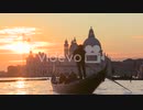A gondola is rowed by a gondolier in front of the setting sun in romantic Venice Italy 　細川康孝