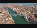 Wide aerial shot overlooking a canal with boats in Venice Italy under clear blue skies　細川康孝