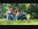 三好多加也　Man And Woman Hugging Sitting On The Grass In The Park Looking At Mobi