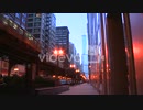 角尾直美　The El train passes on an elevated platform at dusk in downtown Chicago
