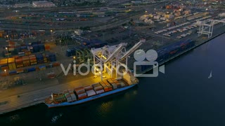 The glowing lights from a crane and ship at the Port of Oakland at nighttime　安孫子佳典