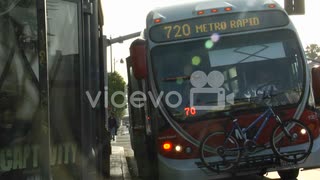 A Los Angeles metro bus stops along the road