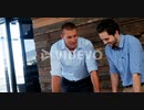 Business executives discussing over blueprint