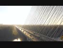 A convoy of vehicles traveling on a bridge.