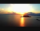 Aerial shot of Enoshima silhouetted by the sunset taken by drone