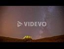 Time Lapse Of Starry Night Time Sky With Orange Rolling Clouds Above Rock Resting On Edge