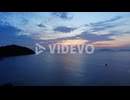 View of the ocean with boats and colorfull sunset