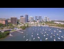 Aerial follow jet ski into harbor full of boats