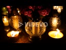 Grave candle lights burning at night on cemetery tomb