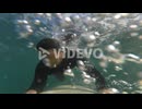 Unknown surfer dude paddling on cool surfboard to catch a wave