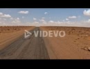 Driving along desert road, car driver pov