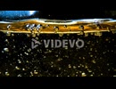 Abstract golden liquid with rising bubbles pattern on dark background