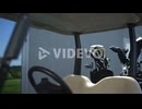 Golf players walking together at cart