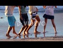 Cheerful group of friends dancing on the beach