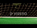 Football in front of a goal with confetti falling
