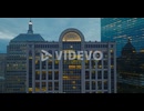 Pull back shot of illuminated interior of high rise commercial building at dusk