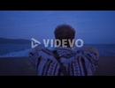 The man looking at the sea and the moon at night
