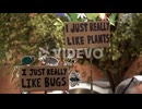 In slow motion two handmade cardboard protest placards read