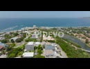 Forwards fly above luxury residencies above sea coast