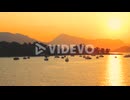 Yachts and sailboats in bay on beautiful golden sunset