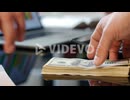 Hand giving dollar bills on office table