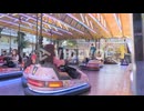 masked children have fun riding bumper cars at amusement park