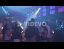 asian girls look at phones in a colorful night club