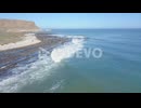 Dramatic aerial of surfing along coast in South Africa