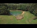 Drone Shot Orbiting Scenic Lake On Edge of Woodland
