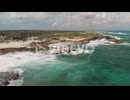 Forwards fly above tourists admiring interesting coastal rocks, sea waves crashing to coast