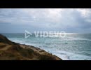 Rocky coast on stormy weather, big waves breaking on shore, restless sea