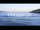 cantabrian sea tide enters secluded playa de la arena sunset glow low aerial