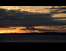 sunset over a lake with dramatic clouds
