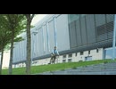 View from below of young man riding a bike close to a huge building