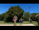 Cheerful boys jumping into outdoor swimming pool on a summer day