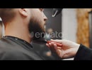 A Professional Hairdresser Dries His Beard with a Hair Dryer