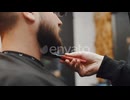 A Professional Hairdresser Dries His Beard with a Hair Dryer