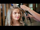 Woman Getting Hair Styled With Curling Iron