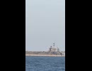 Sailors onboard a passing ship in the northern Arabian Sea have a barbecue while watching