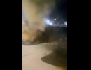 Civilians film the remains of a liquid-fueled Iranian ballistic missile that fell on the