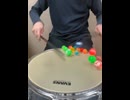 superball on snare drum with sticks