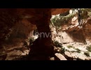 View From Inside a Dark Cave with Green Plants and Light on the Exit
